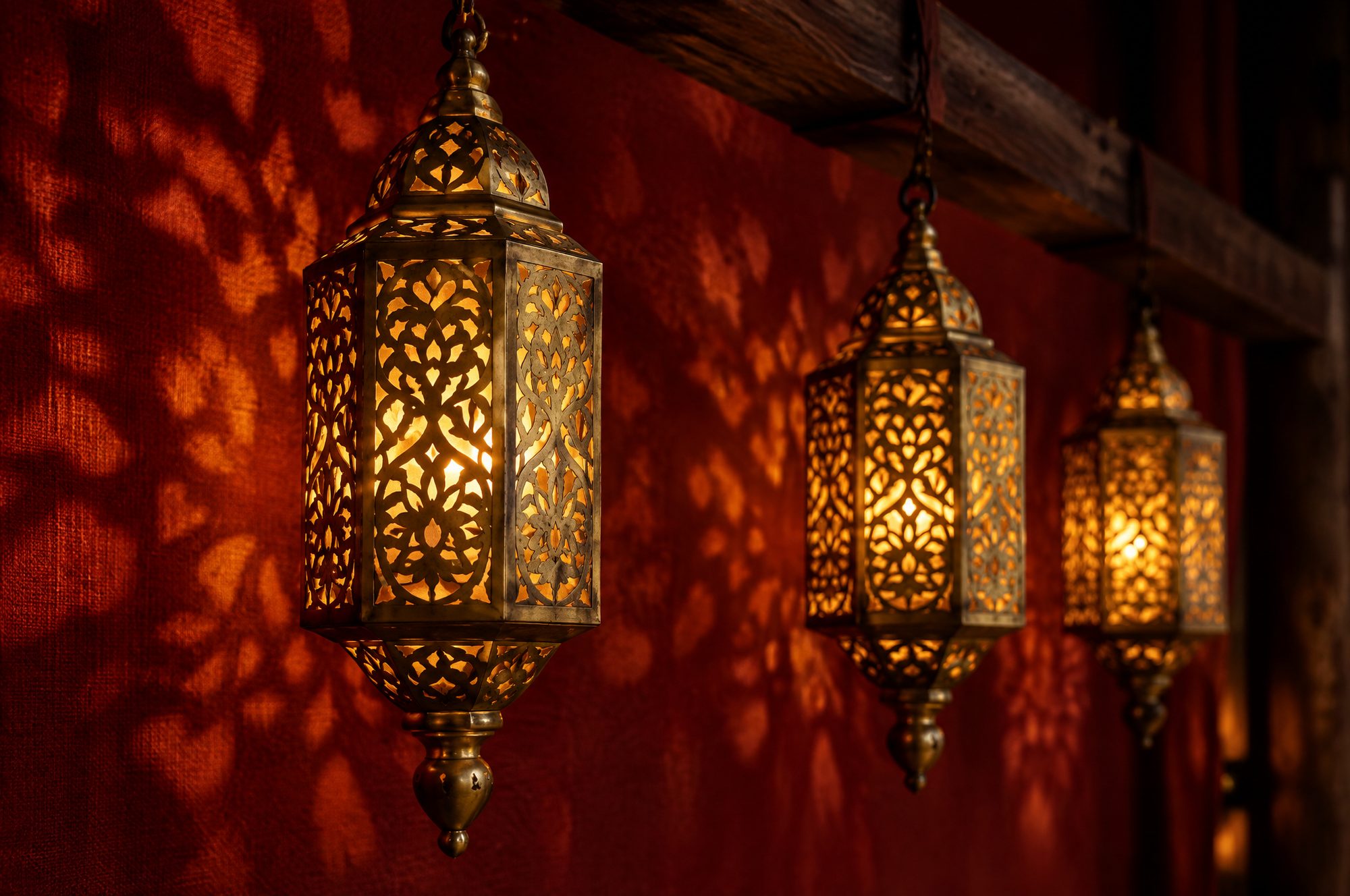Brass Khmer lanterns glowing on red linen