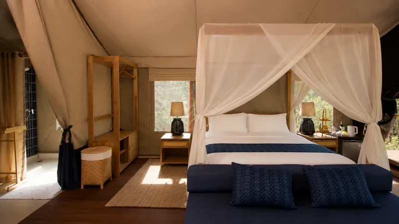 Tham Sakoen tent with a canopy bed facing the bamboo